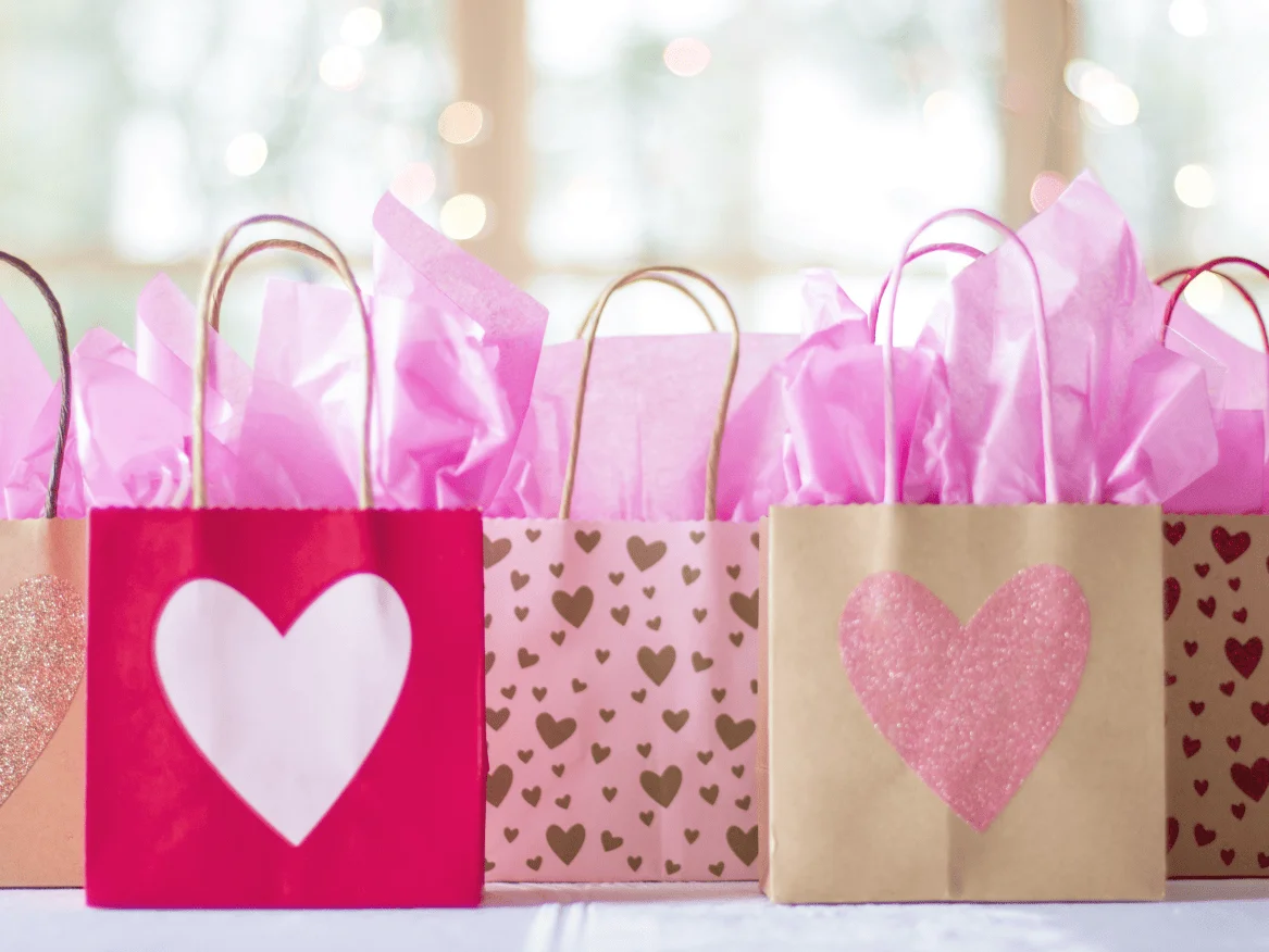 lovely paper bags filled with game prized for bridal shower