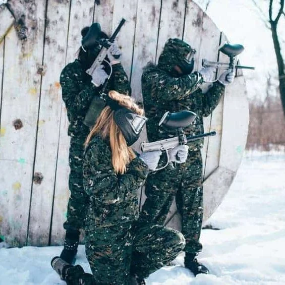 three women in camo playing paintball