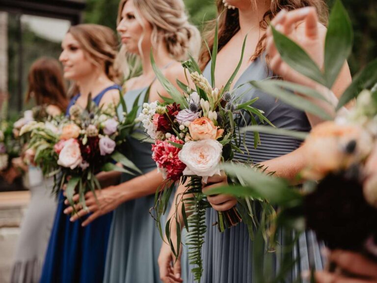 Stunning bridesmaids holding beautiful bouquets of flowers. Can a bridesmaid be married? It doesn't matter!