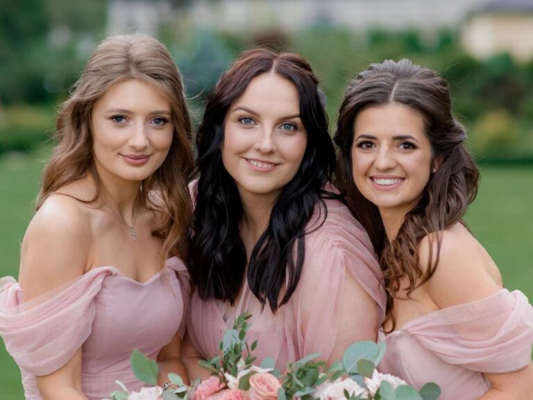 Three bridesmaids with beautifully done hair and exquisite makeup. Do bridesmaids pay for hair and makeup?