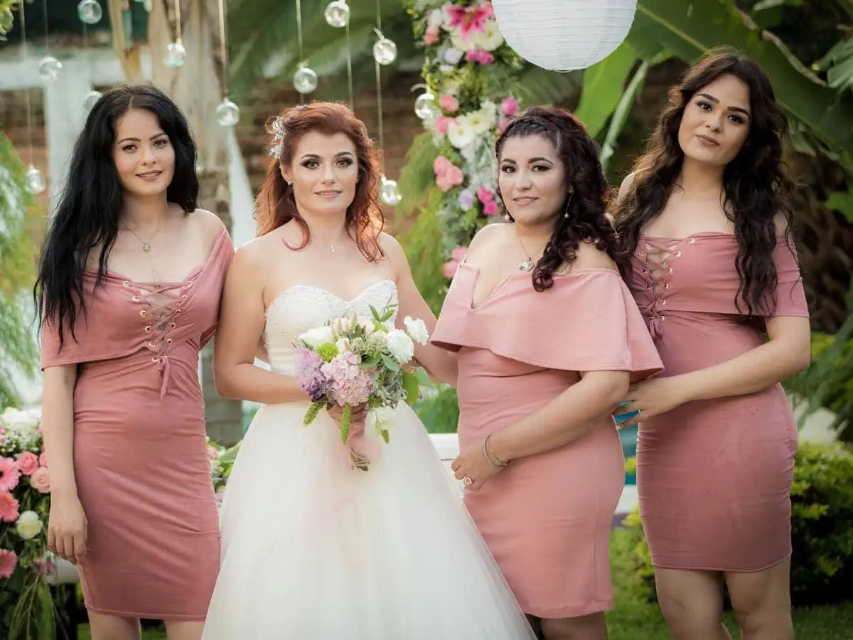 Picture of The Bride, Maid of Honor, and Bridesmaids with maid of honor wearing a different dress to the bridesmaids