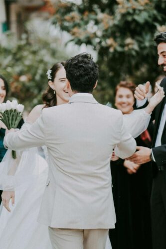 Bride and groom joyfully greeting guests