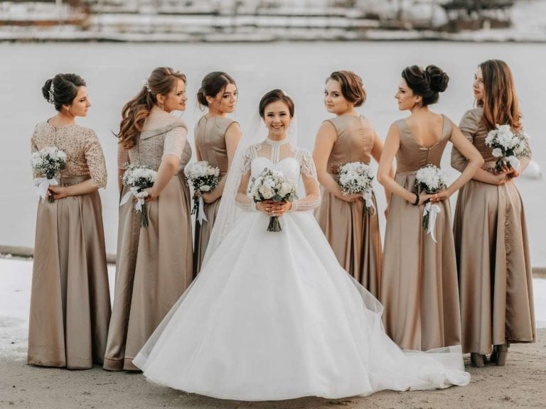 Bridesmaid Pose Ideas with bride at center and bridesmaids looking back over the shoulder