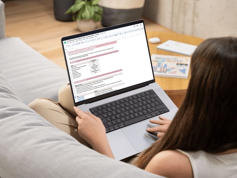 Bachelorette party budget template being used by woman sitting on a couch